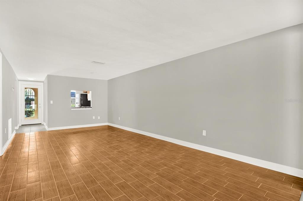 4455 Rustic Drive New Port Richey, FL 34652 - Photo 11 of 27 a view of empty room with wooden floor