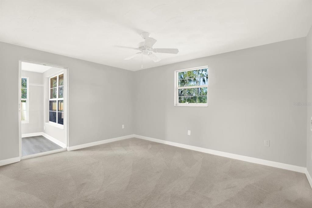 4455 Rustic Drive New Port Richey, FL 34652 - Photo 14 of 27 an empty room with windows and ceiling fan
