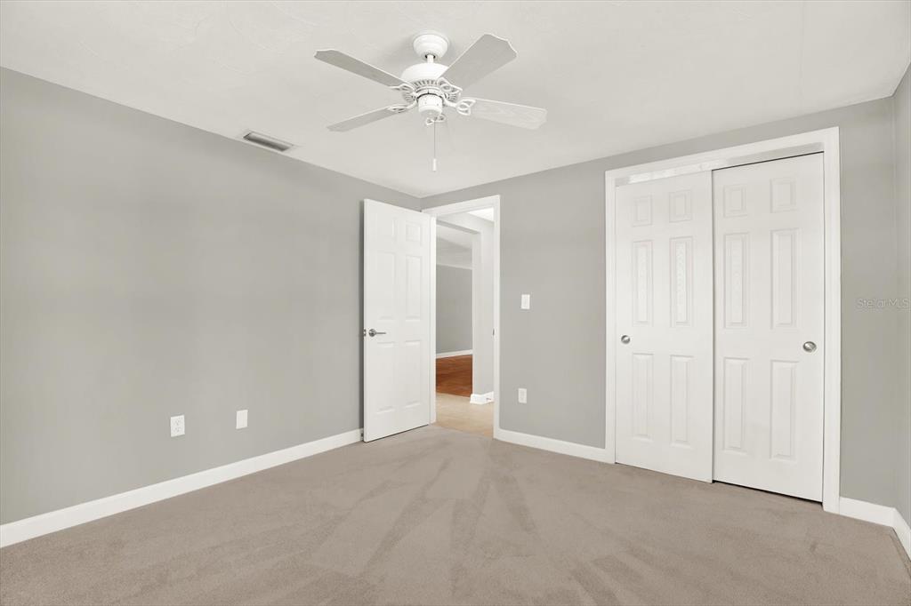 4455 Rustic Drive New Port Richey, FL 34652 - Photo 19 of 27 a view of a room with a ceiling fan and a chandelier fan