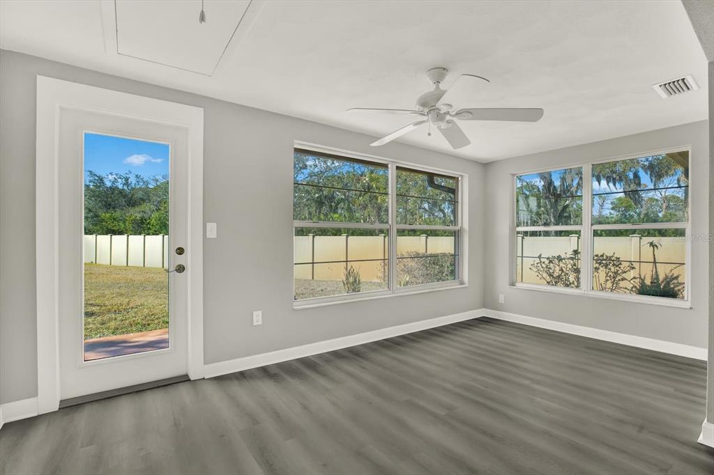 4455 Rustic Drive New Port Richey, FL 34652 - Photo 21 of 27 a view of an empty room with wooden floor and a window