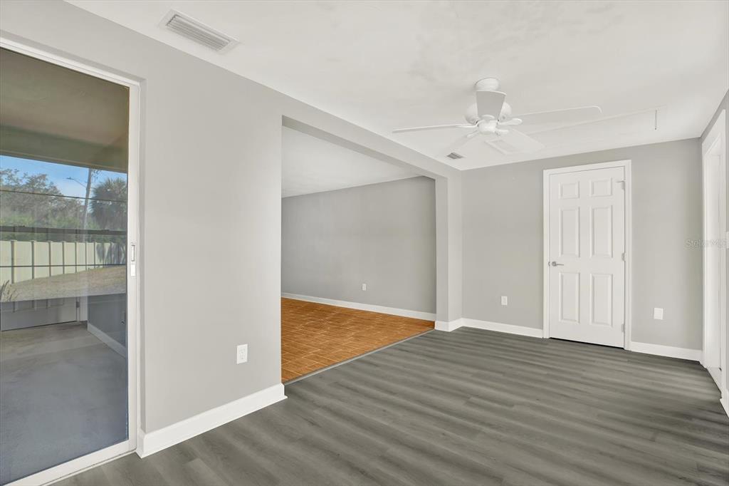 4455 Rustic Drive New Port Richey, FL 34652 - Photo 22 of 27 wooden floor in an empty room with a window