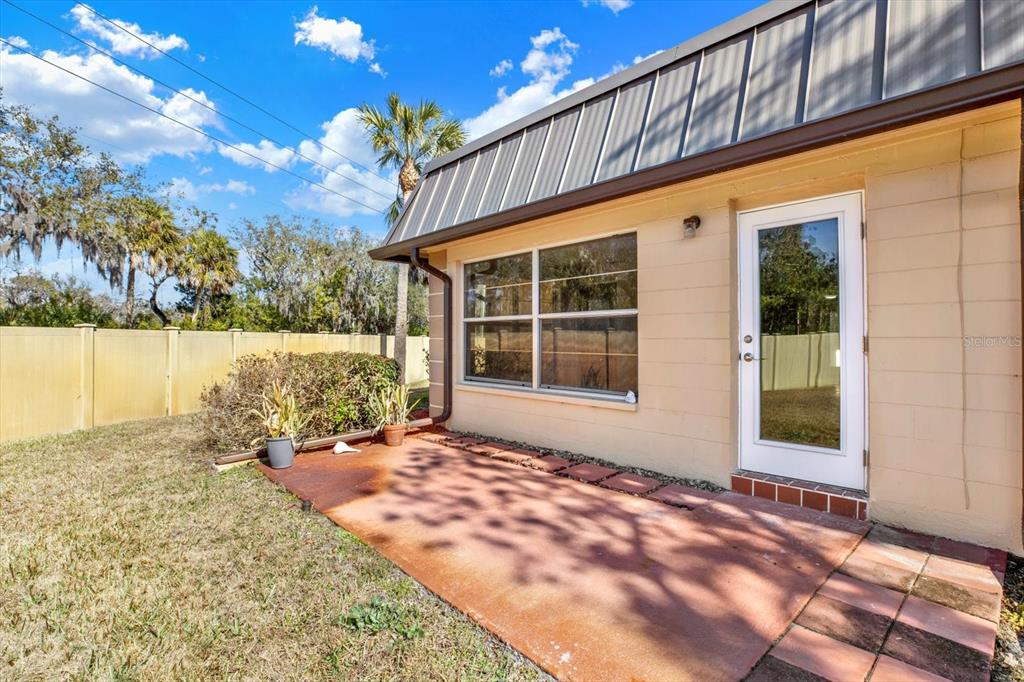 4455 Rustic Drive New Port Richey, FL 34652 - Photo 23 of 27 a view of a house with backyard and sitting area