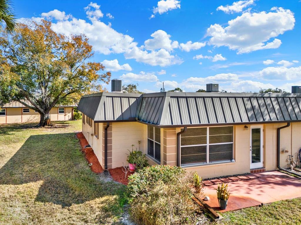 4455 Rustic Drive New Port Richey, FL 34652 - Photo 24 of 27 a view of a house with backyard and sitting area