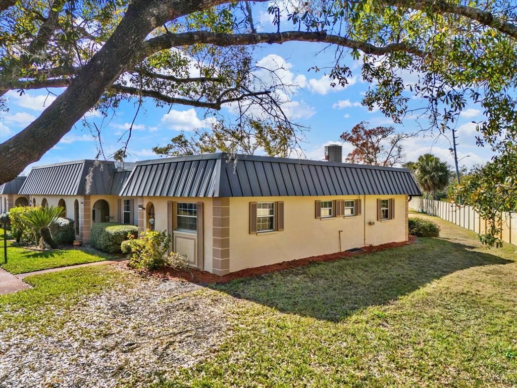 4455 Rustic Drive New Port Richey, FL 34652 - Photo 25 of 27 a view of a house with a yard