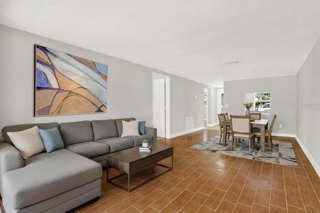 4455 Rustic Drive New Port Richey, FL 34652 - Photo 9 of 27 a living room with furniture and a dining table