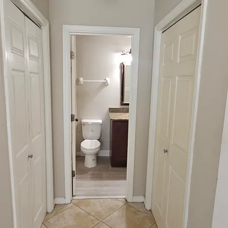 a bathroom view of a toilet and a shower