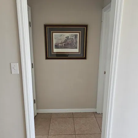 a view of an empty room with closet