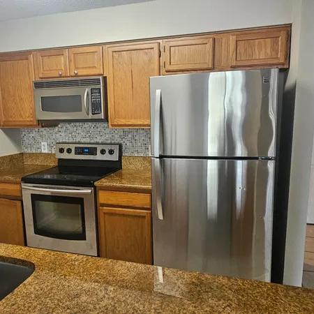 a kitchen with a refrigerator stove and microwave