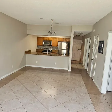 a view of a kitchen with a sink and a refrigerator