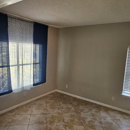 an empty room with a empty space and windows