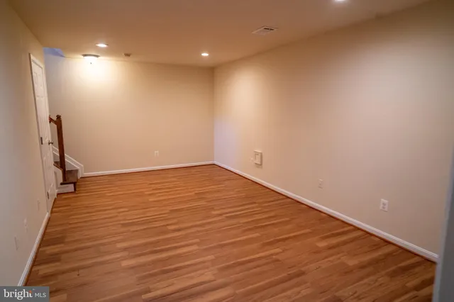 a view of room with wooden floor and staircase