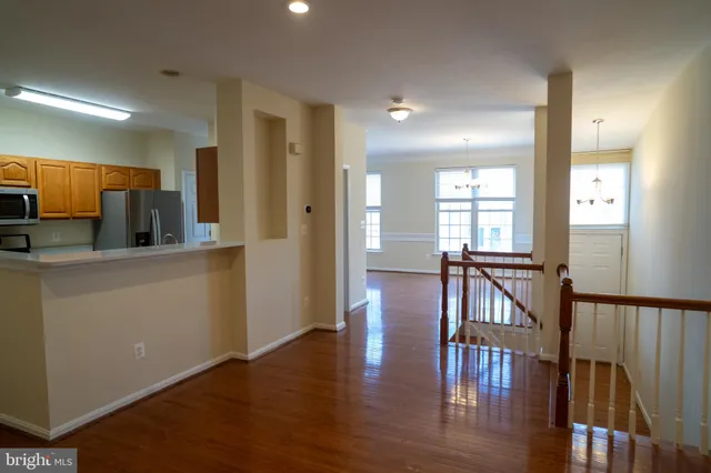 a kitchen with stainless steel appliances granite countertop a refrigerator a stove a sink dishwasher with a dining table and chairs