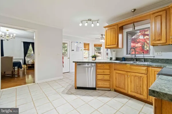 a kitchen with stainless steel appliances granite countertop a sink and a refrigerator