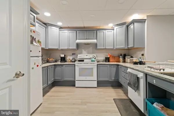 a large kitchen with lots of counter and chairs