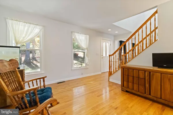 a view of an entryway with wooden floor and windows