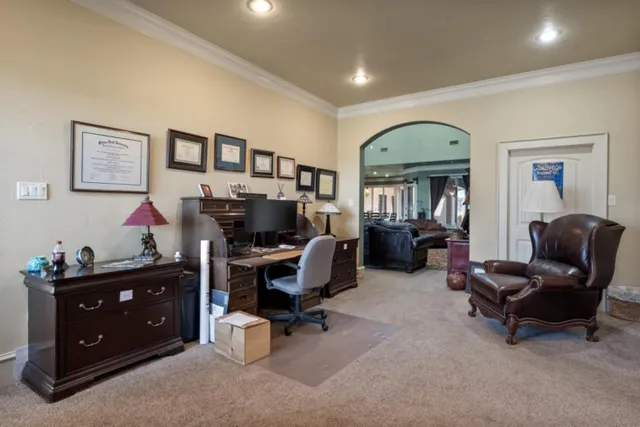 a livingroom with workspace and a couch