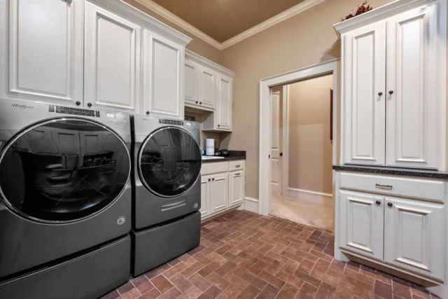 a utility room with sink dryer and washer