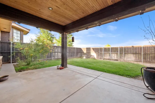 a view of a house with backyard and porch