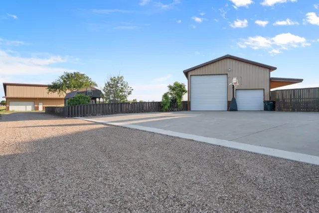 a view of a house with backyard and bushes