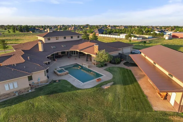 an aerial view of a house with a lake view