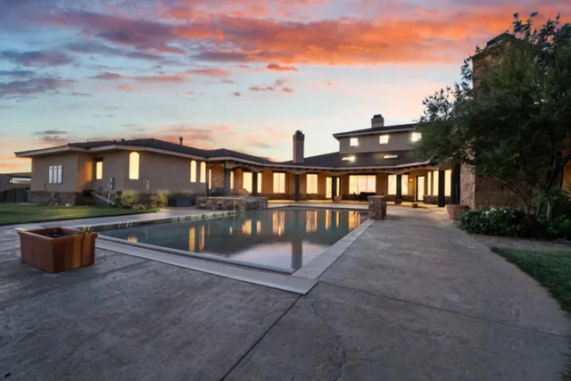 a view of a patio with couches chairs and a fire pit