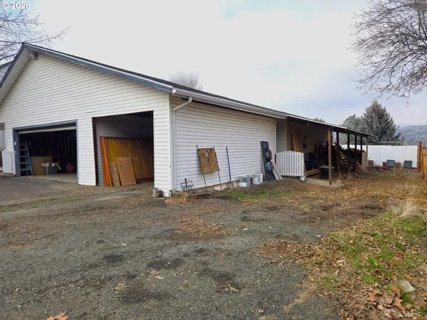 a view of a house with a yard and garage