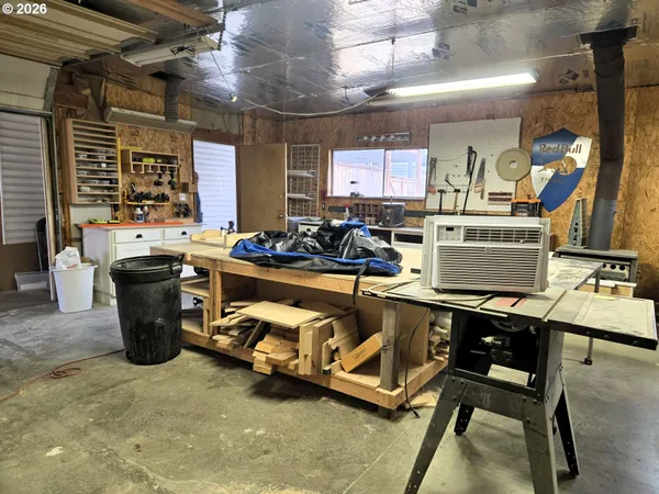 a room with stainless steel appliances kitchen island granite countertop lots of counter and chairs