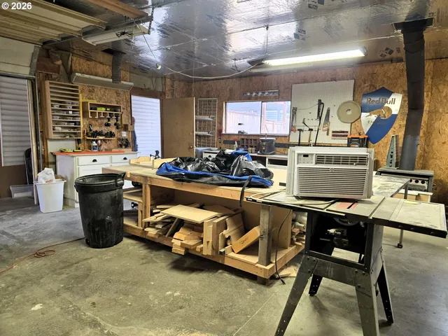 a room with stainless steel appliances kitchen island granite countertop lots of counter and chairs