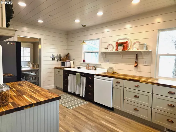 a kitchen with stainless steel appliances kitchen island granite countertop a sink and cabinets