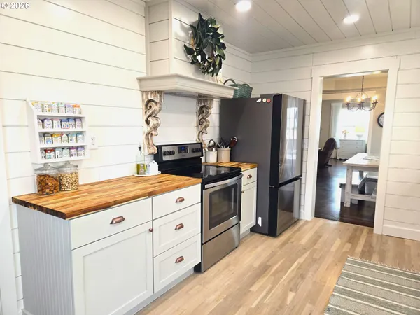 a kitchen with stainless steel appliances kitchen island granite countertop a refrigerator and a stove