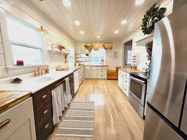 a large kitchen with stainless steel appliances kitchen island granite countertop lots of counter top space and cabinets