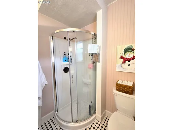 a bedroom with a bed and closet with wooden floor