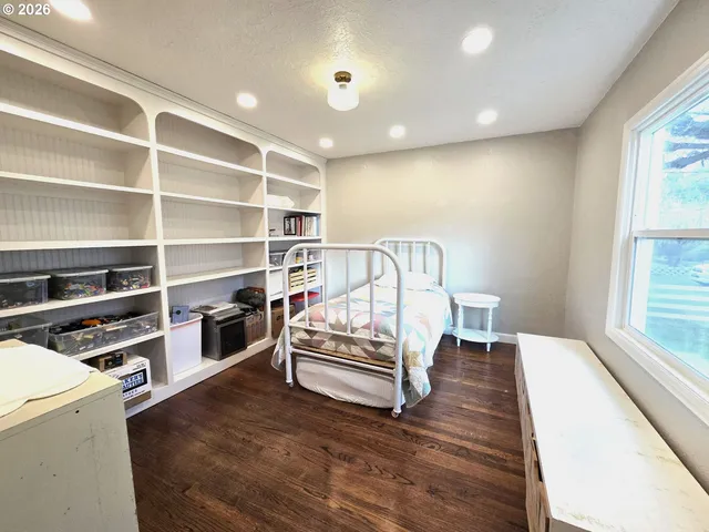 a bed room with a bed and a night stand