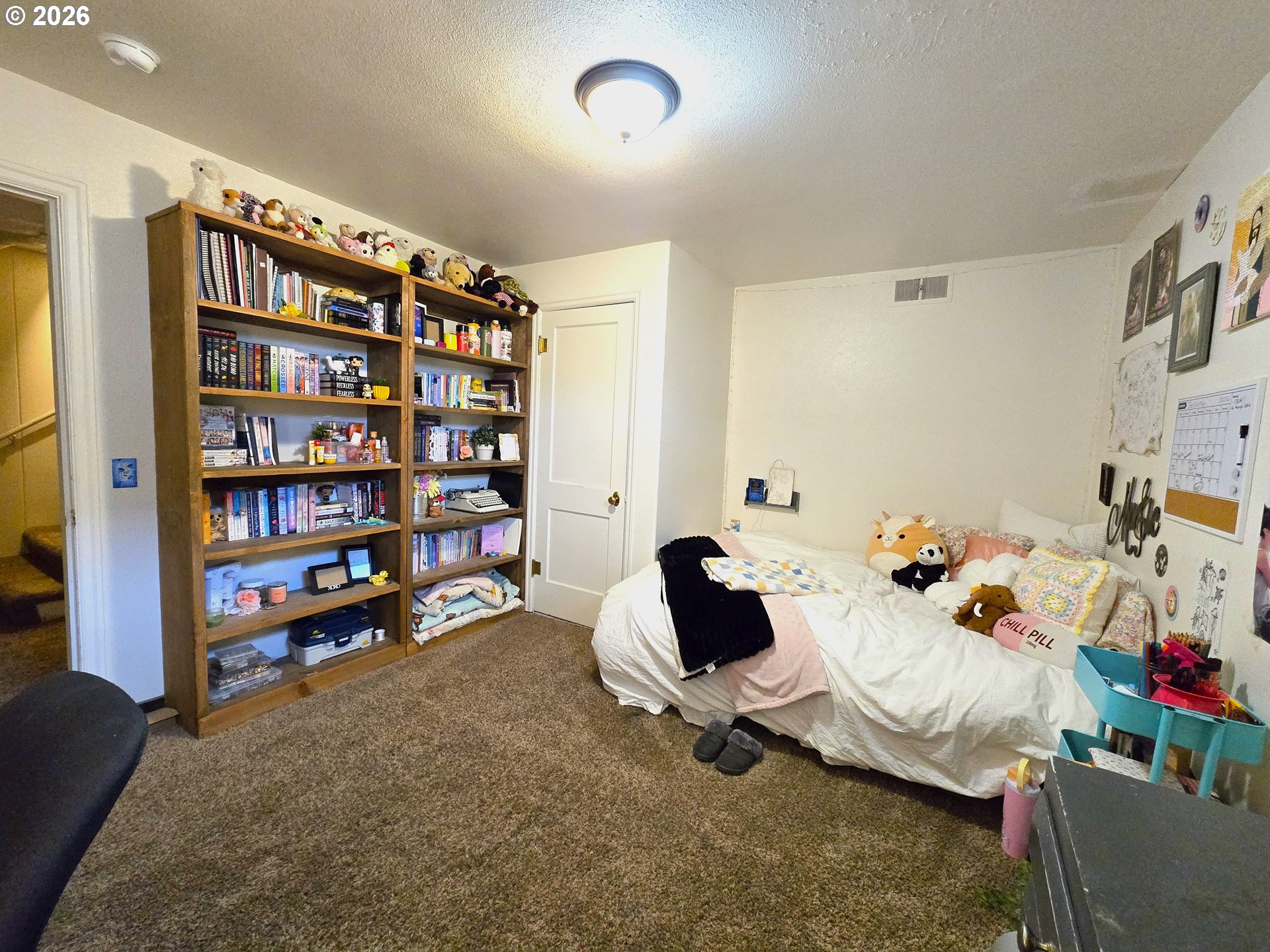 633 Southeast Hillcrest Road John Day, OR 97845 - Photo 44 of 48 a bedroom with furniture and a book shelf