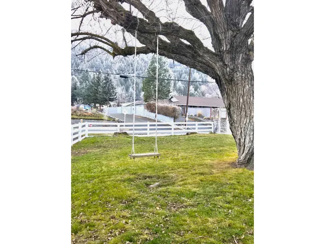 a swimming pool with outdoor seating and yard
