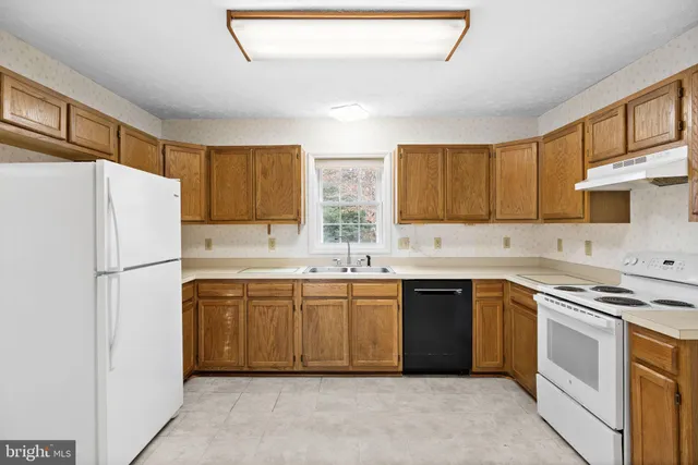 a kitchen with a white cabinets and white appliances