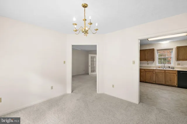 a view of a kitchen with a sink and dishwasher with wooden floor