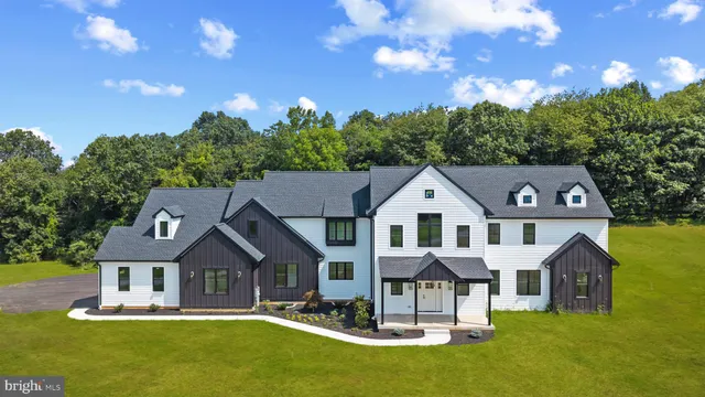 a front view of a residential houses with yard and green space