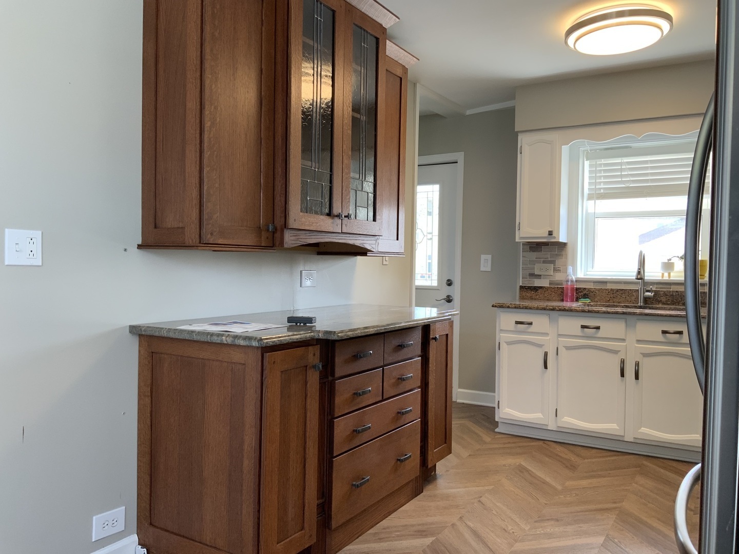 7835 West Berwyn Avenue Chicago, IL 60656 - Photo 5 of 17 a kitchen with granite countertop cabinets stainless steel appliances a sink and a window