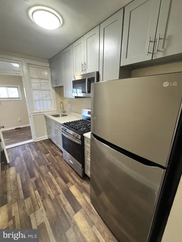 a kitchen with stainless steel appliances granite countertop a sink stove oven and refrigerator