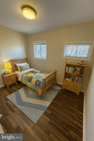 a view of a room with wooden floor and window