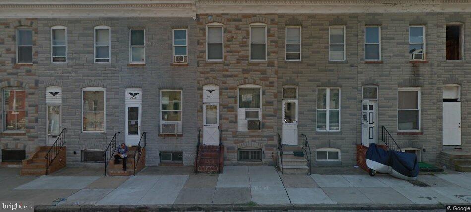 2017 Ramsay Street Baltimore, MD 21223 - Photo 1 of 1 a brick building with a bench and a table