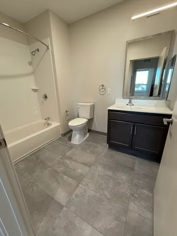 a spacious bathroom with a bathtub and a toilet
