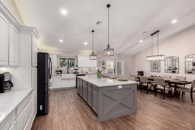 a large kitchen with a table and chairs