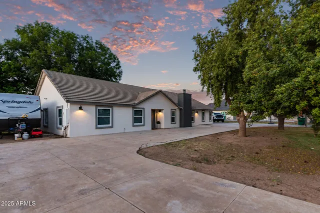 a house that has a tree in front of it