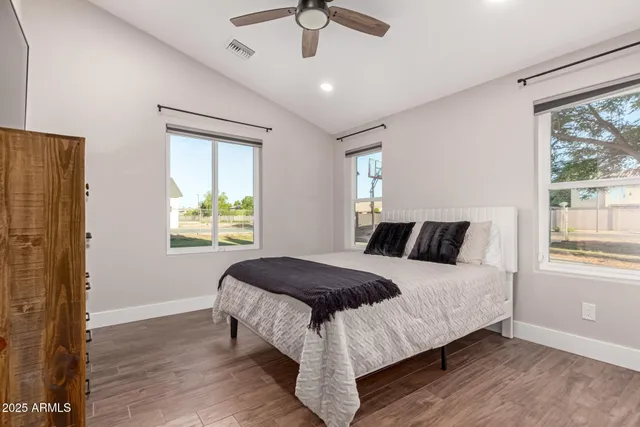 a bedroom with a bed and a window