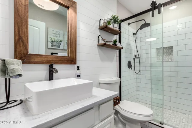 a living room with furniture a flat screen tv and a window