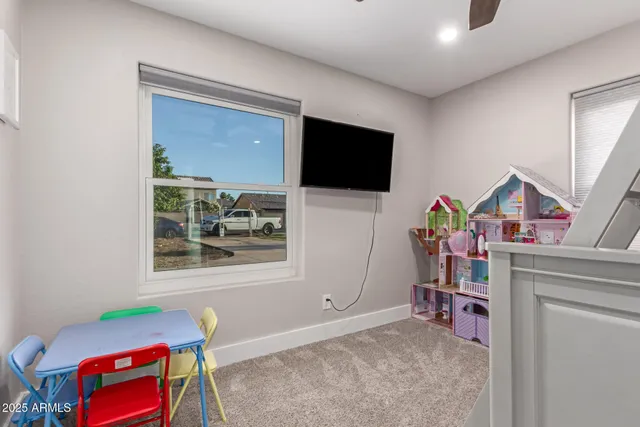 a bedroom with a bed and a chair