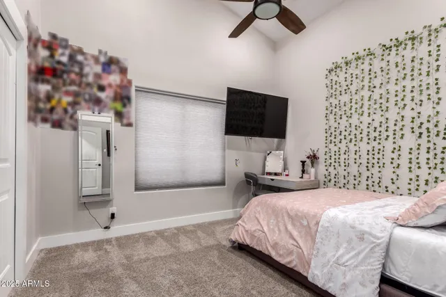 a bedroom with a large bed and a chandelier