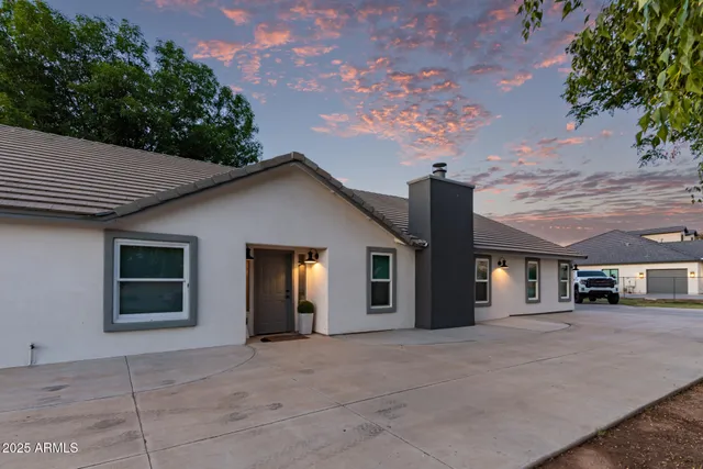 a view of a house with a backyard and a garage